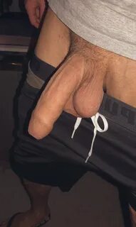 Guy with his shorts pulled down showing off his very big cock with trimmed ...