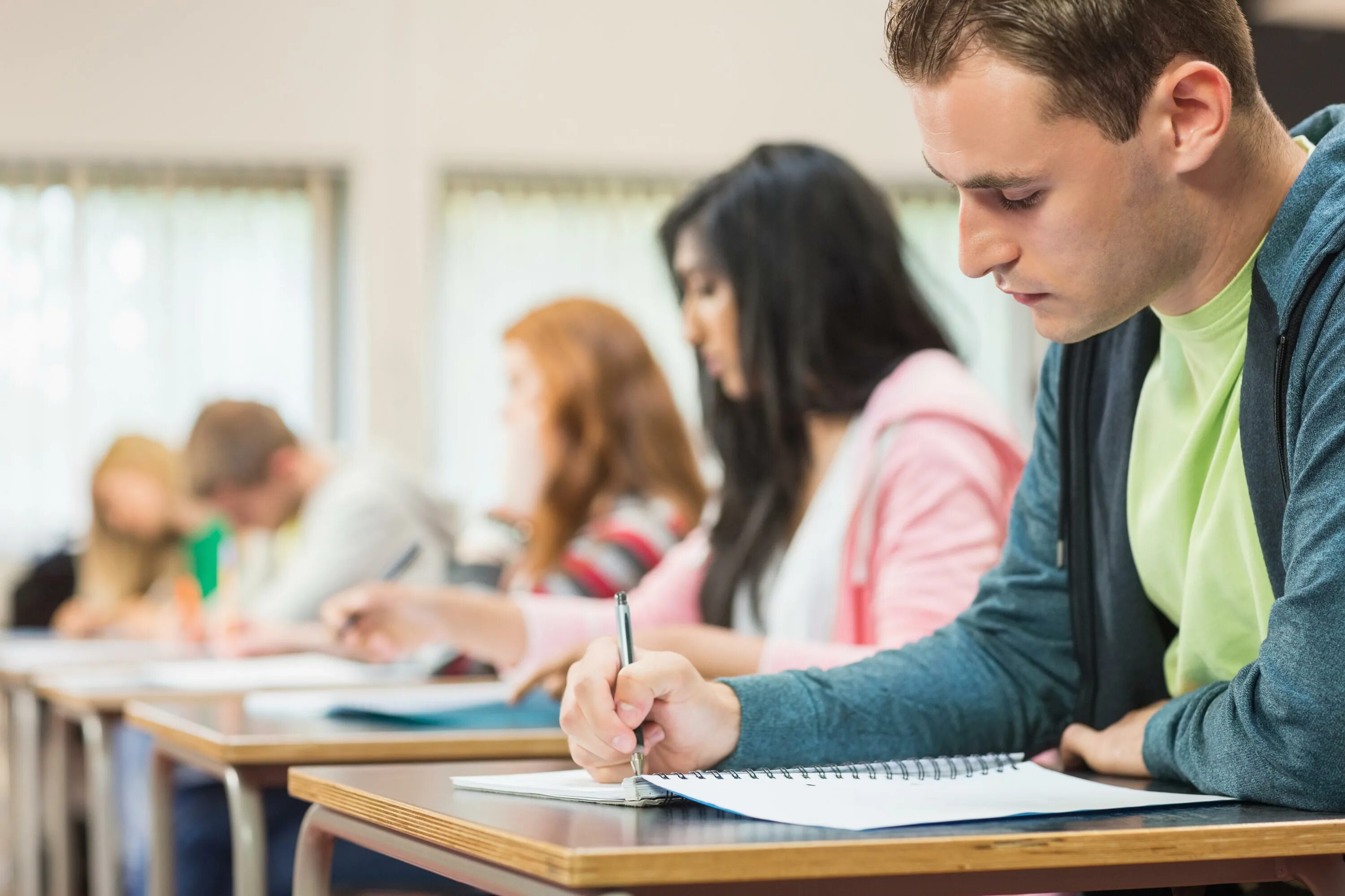 Examination student. Студент за партой. Экзамен. Студент ЕГЭ. Школьник готовится к ЕГЭ.