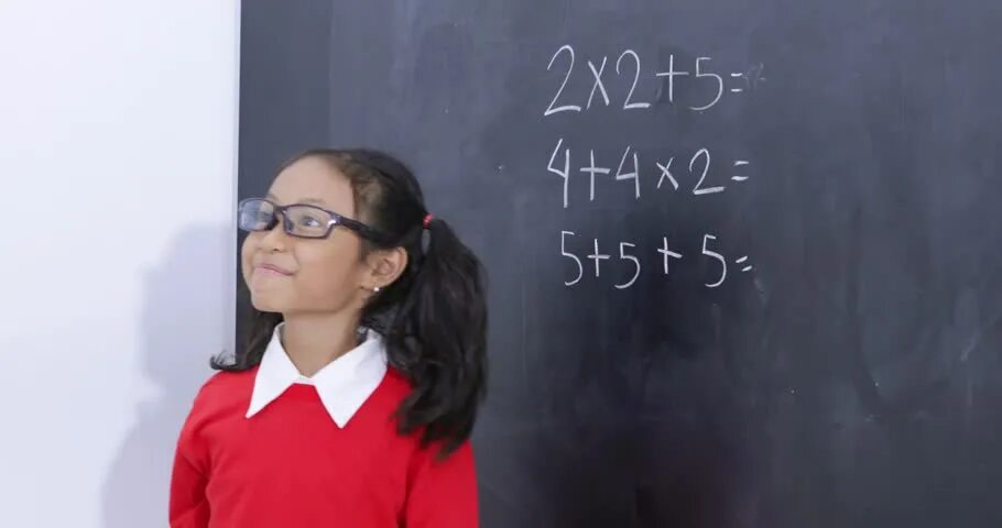 Physkids. Interesting physics. Caring teacher helps a young schoolgirl with Math Assignment. The girl is counting on her fingers.