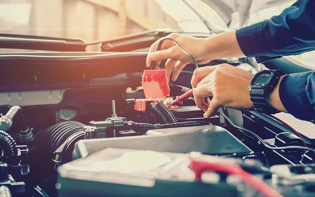 Техническое обслуживание акб автомобиля. Механик в гараже. Использование и обслуживание батареи спецтехника. Моторист. Машина работает стабильно.