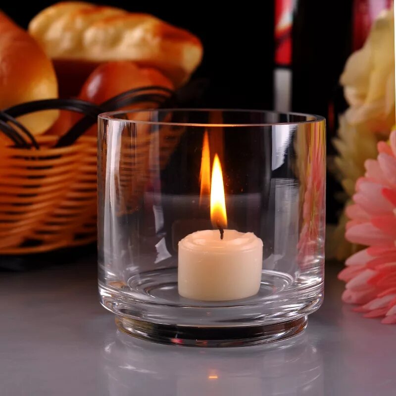На столе стоит свеча которая отражается. Красивые свечки. Шикарные свечи. Дизайнерские свечи. Свеча в бокале.