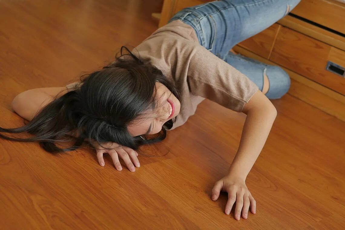 Broken on the floor. Woman Falling down. Slip on the Floor.