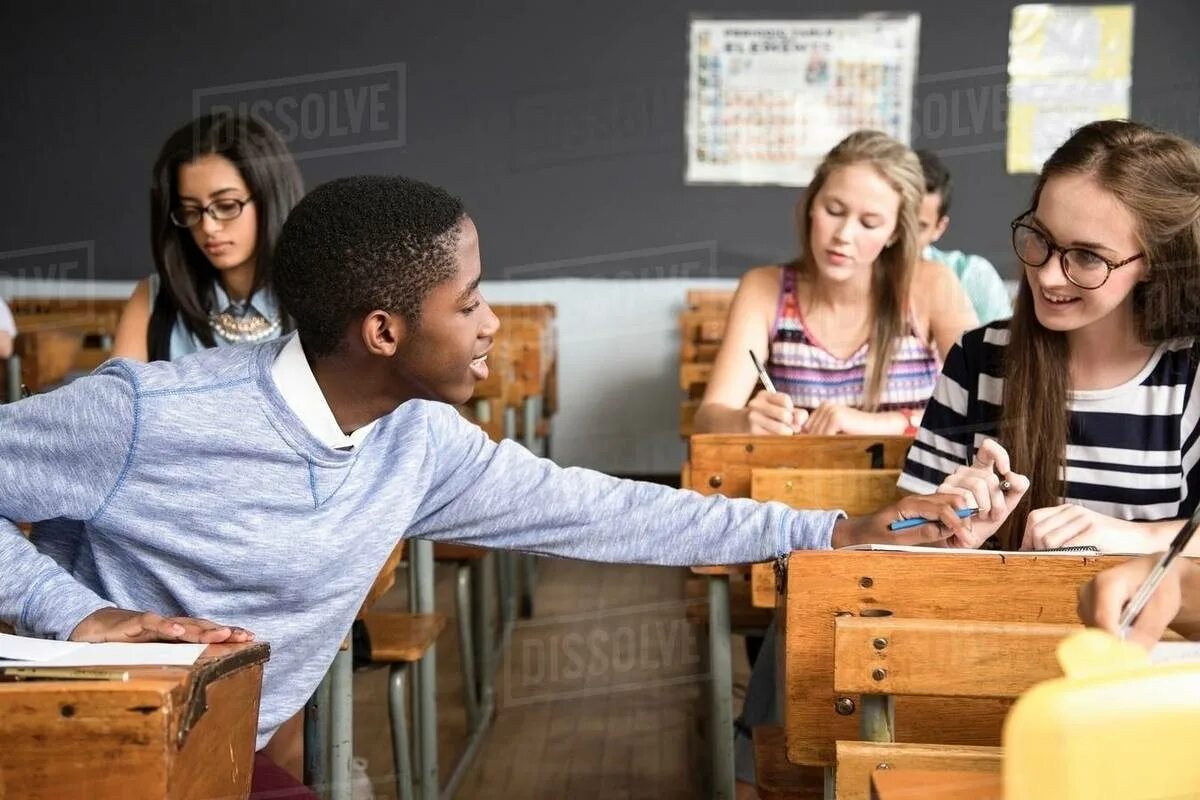 Helping in the Classroom. Students sitting in class. Helping in class. Classroom students sitting Desk. Were the students in the classroom