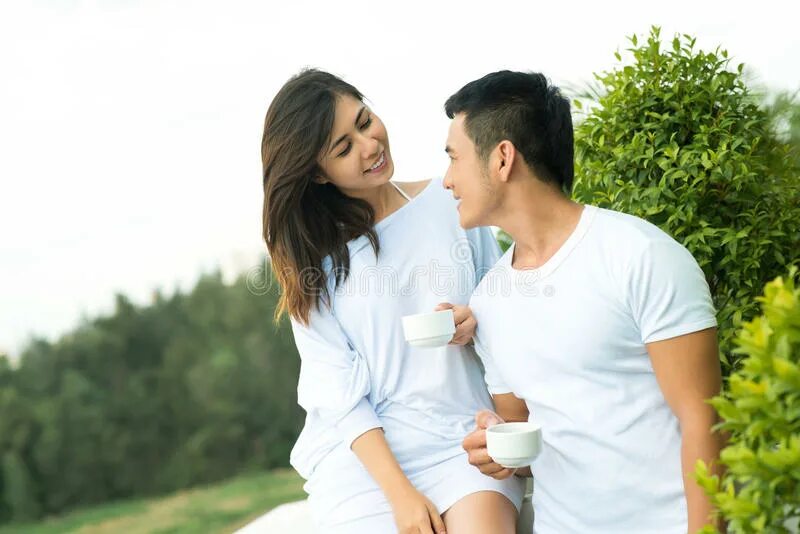 A couple of young people looking at the City from the balcony. Meet couple