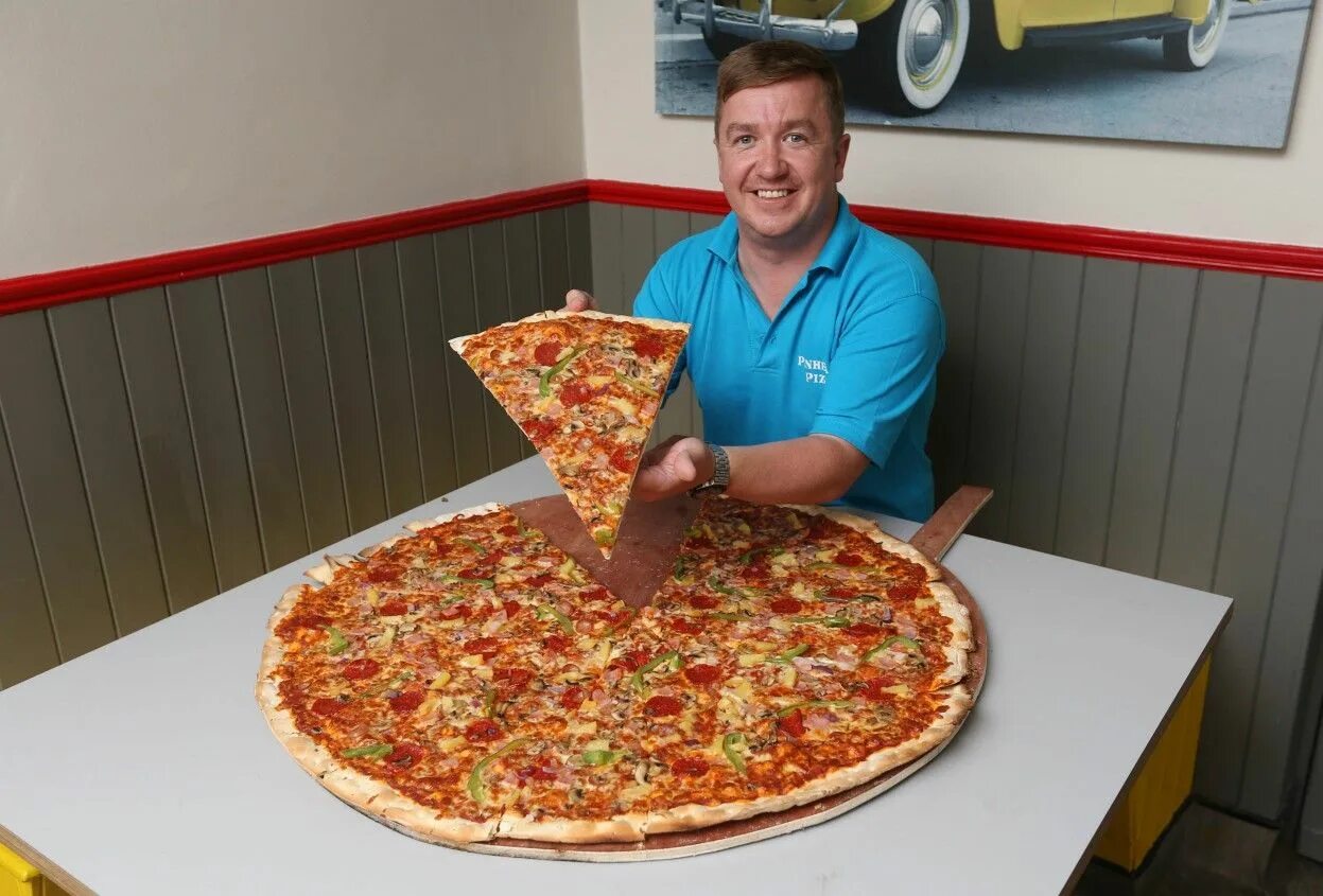 Большая пицца. Огромная пицца. Гигантская пицца. Огромный кусок пиццы. Самые большие питания