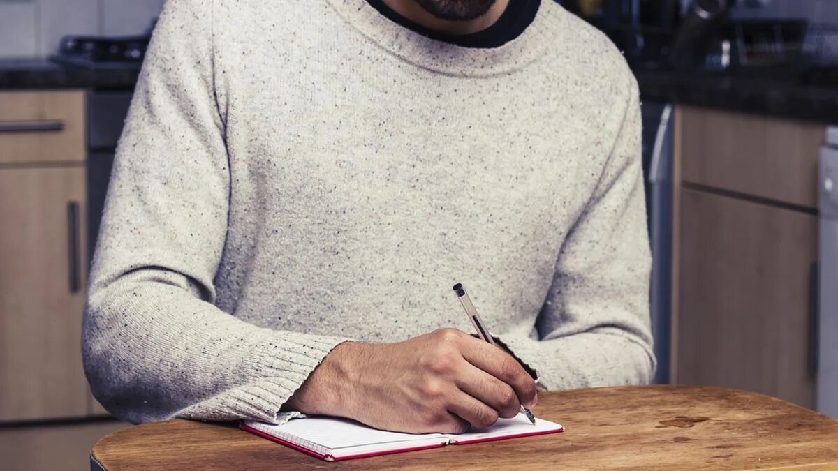 Sometimes mistakes. Writing man with a feltpan. the man is writing pnj. wirite photo. common writing mistakes photo.
