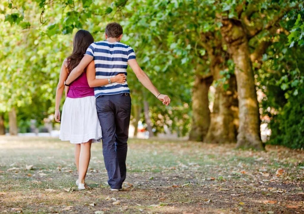 Парочка в парке. Парень и девушка в парке. Мужчина и женщина гуляют в парке. Пара гуляет в парке.