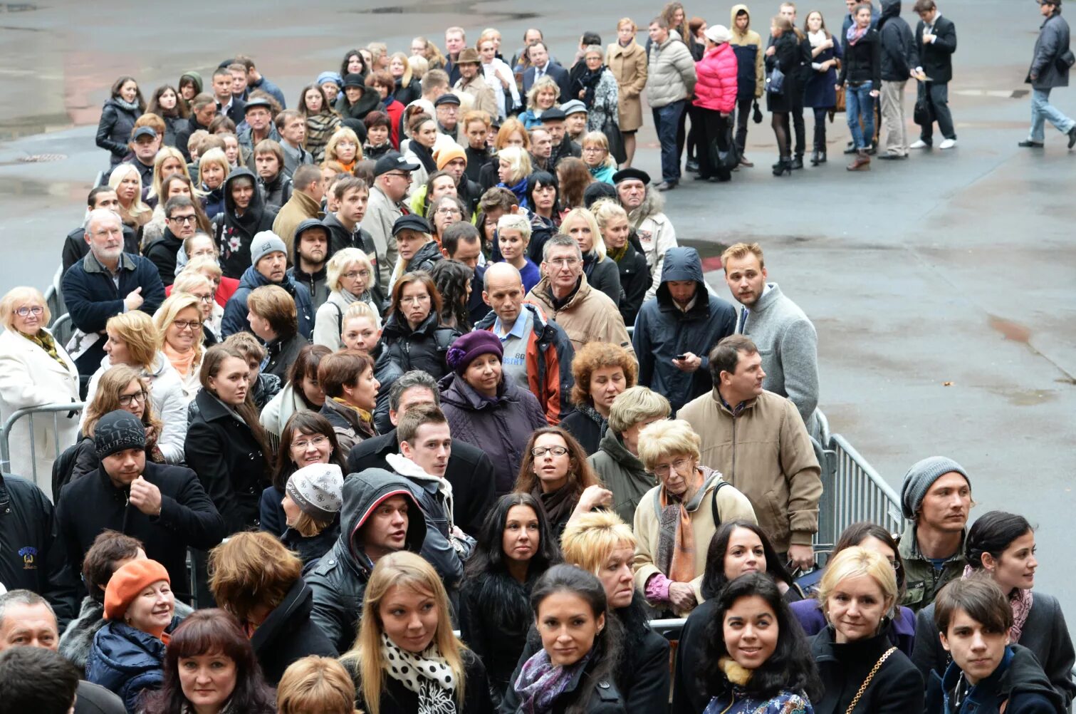 Очередь стоит обращать внимание. Толпа людей в очереди. Много людей. Очередь из клиентов. Толпа людей на улице.