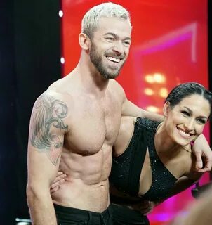 Nikki Bella slips into a red bikini while enjoying some downtime with Artem  Chigvintsev and their