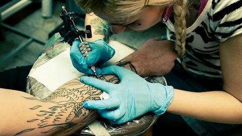 Girl getting tattoo