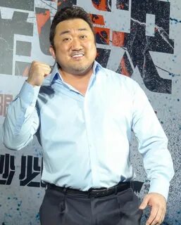 a man standing in front of a poster with his fist up and fists raised to th...