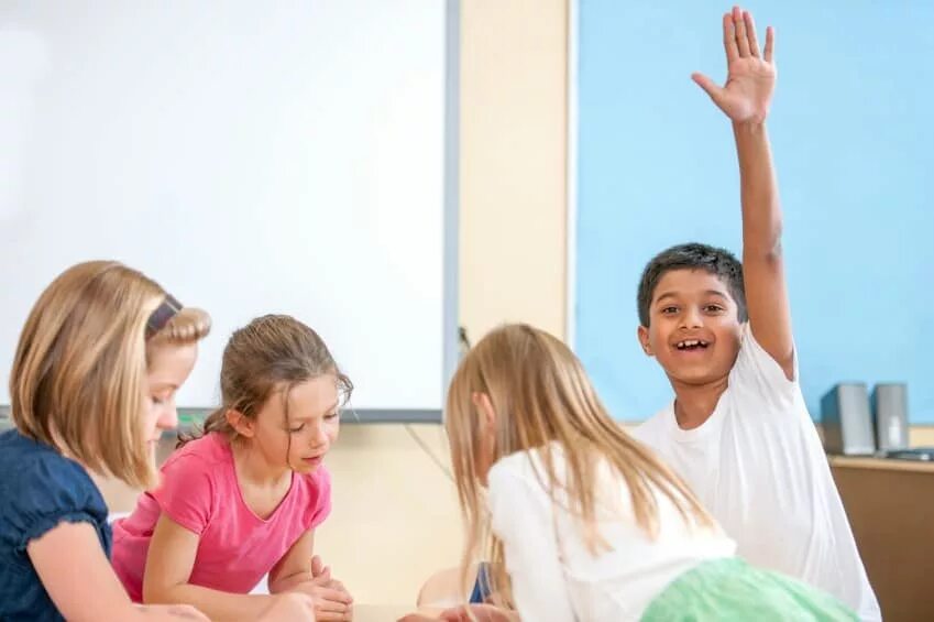Raise children. Школу stretching Kids. Фото dusting the Classroom children. Kid raising hand in the Classroom. Child raising hand.