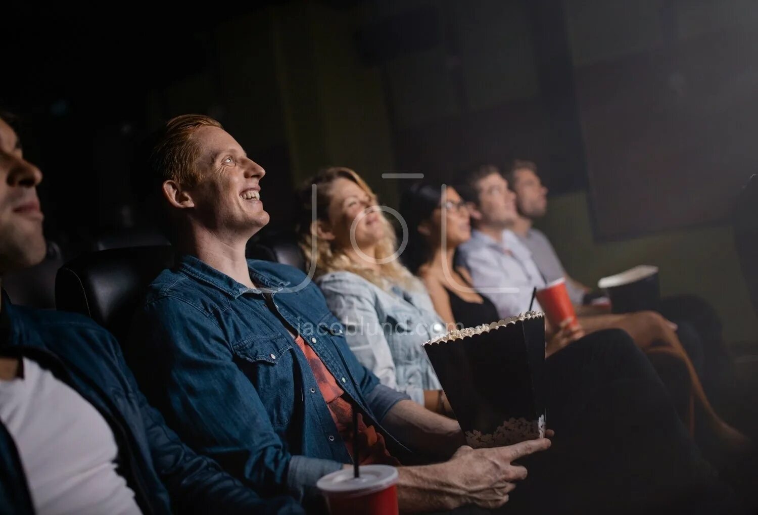 Bunch of friends watching movie. Friends watch a movie