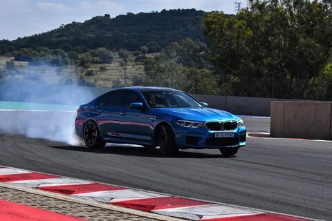 BMW M5, model year 2005-, black, driving, diagonal from the front, frontal  view, test track, Drift, drifting Stock Photo - Alamy