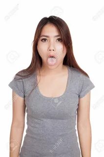Funny young Asian woman sticking out tongue isolated on white background - ...