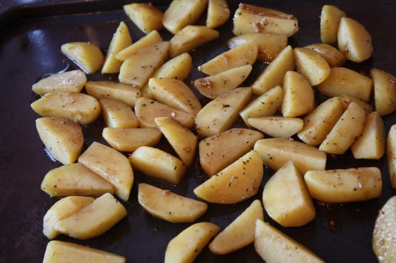 Рецепт запеченного картофеля дольками. Дольки из картофеля. картошка дольками на противне. картофель запеченный в духовке дольками в соевом соусе. картофель и перец в духовке дольками.