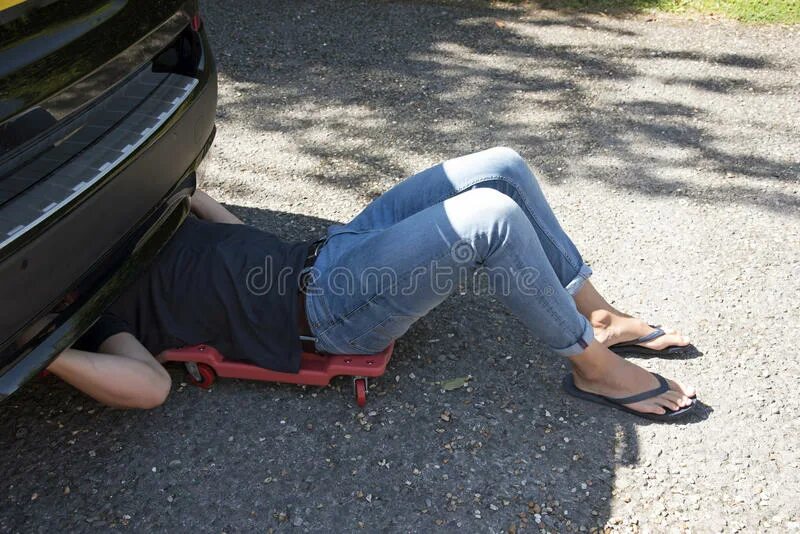 Автослесарь под машиной. Автомобиль сбил девушку. Механик под машиной. Человек под машиной. Мужчина лежит под машиной.