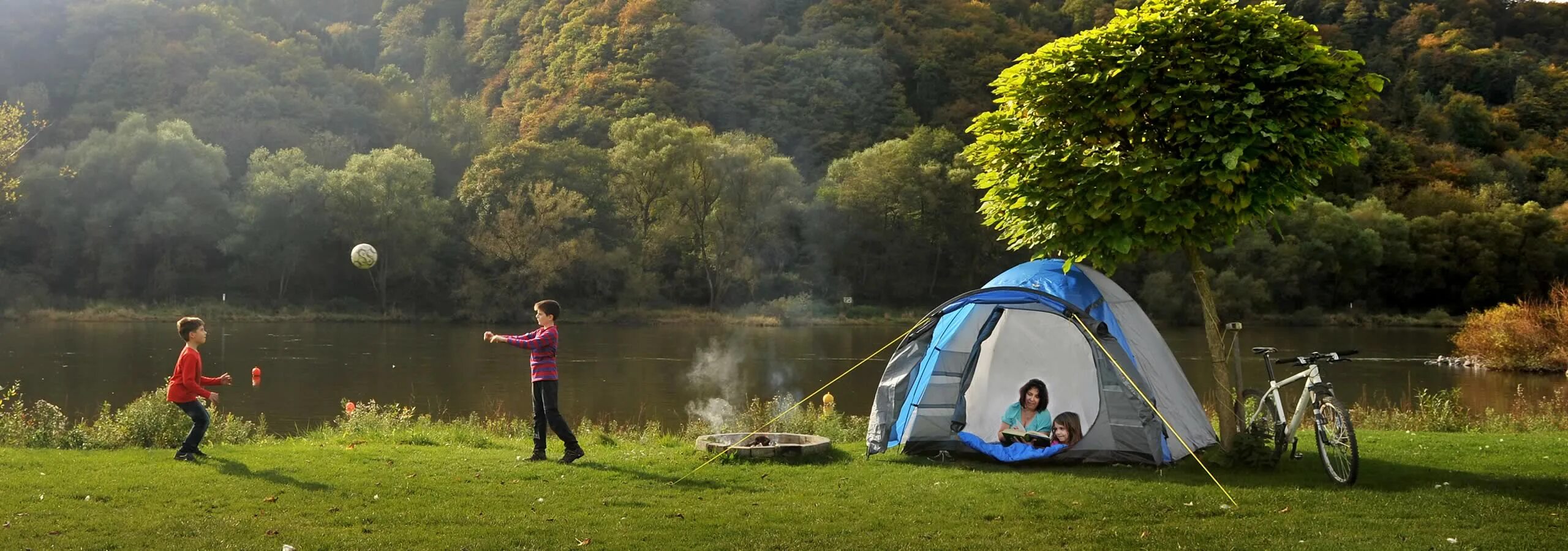 Camping river. Кемпинг у реки. Палатка в лесу у озера. Баннер пикник. Палатка с местом для велосипеда.