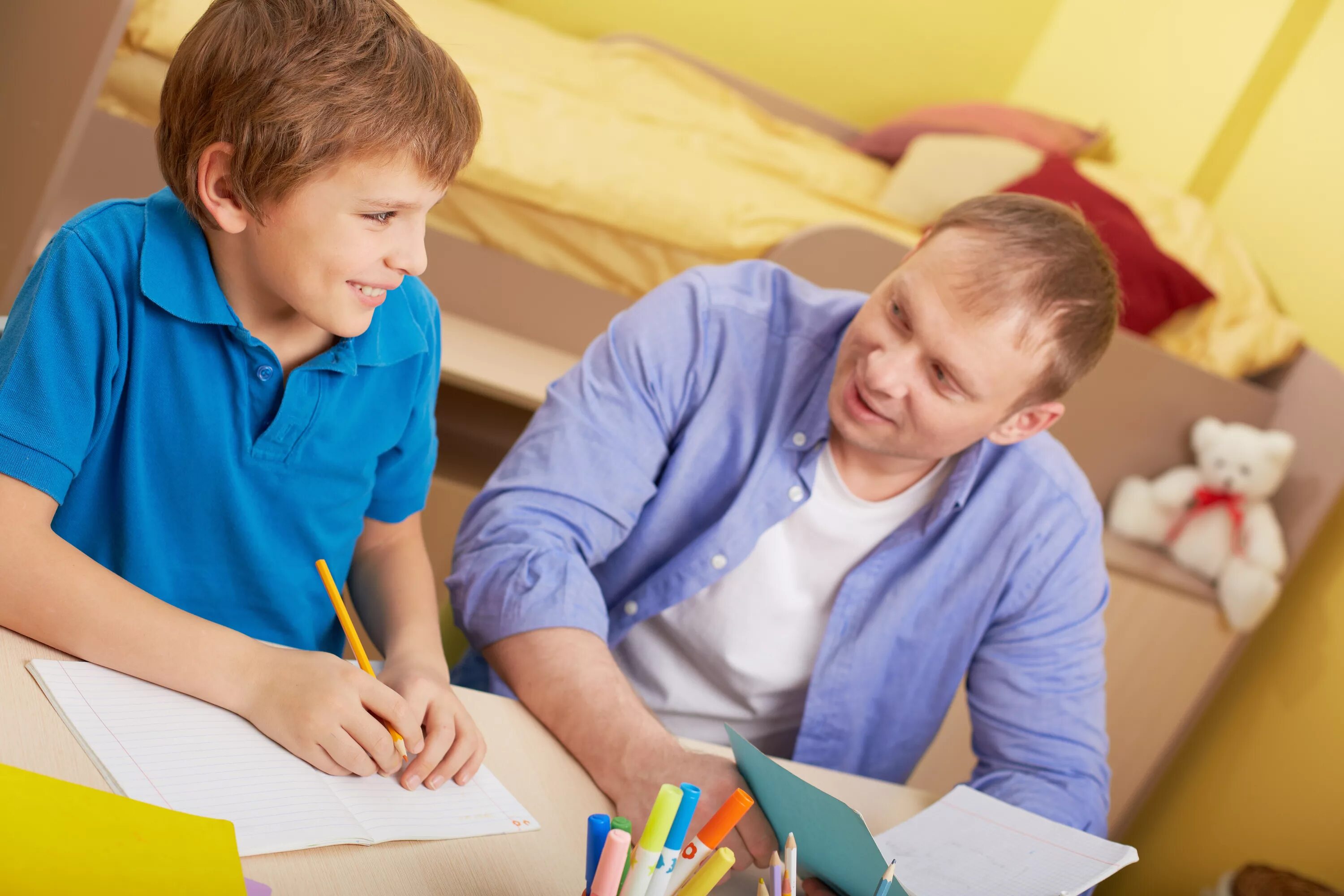 His father a teacher. Ребенок делает уроки. Папа обучает сына. Дети на уроке. Ребенок учит уроки.