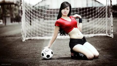 women's red crop shirt, soccer, balls, kneeling, Asian.