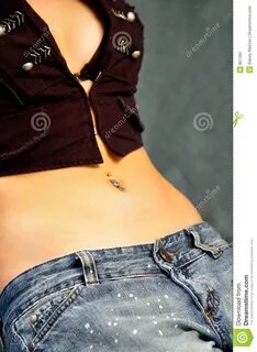 Photo about Tummy with belly button piercing. 