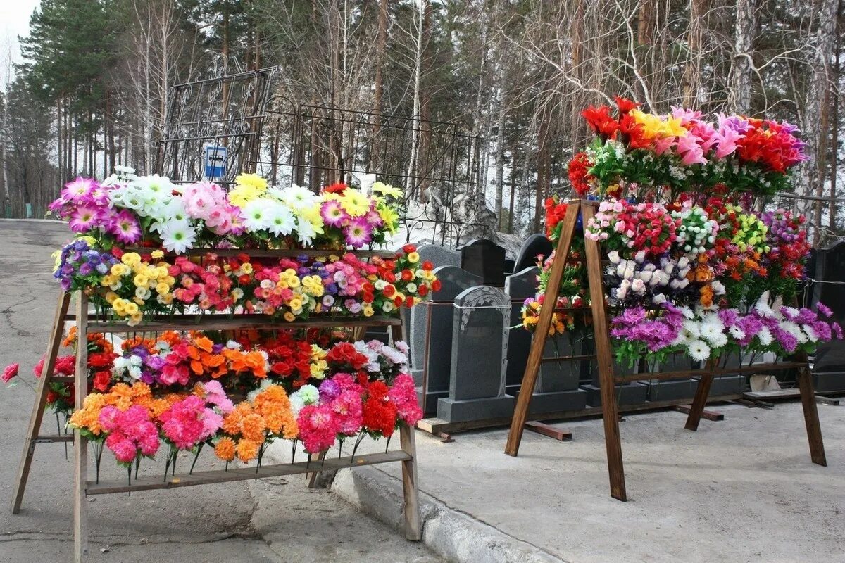 Искусственные цветы на кладбище. Стойка для искусственных цветов на кладбище. Пластиковые цветы для кладбища. Торговля искусственными цветами на кладбище.