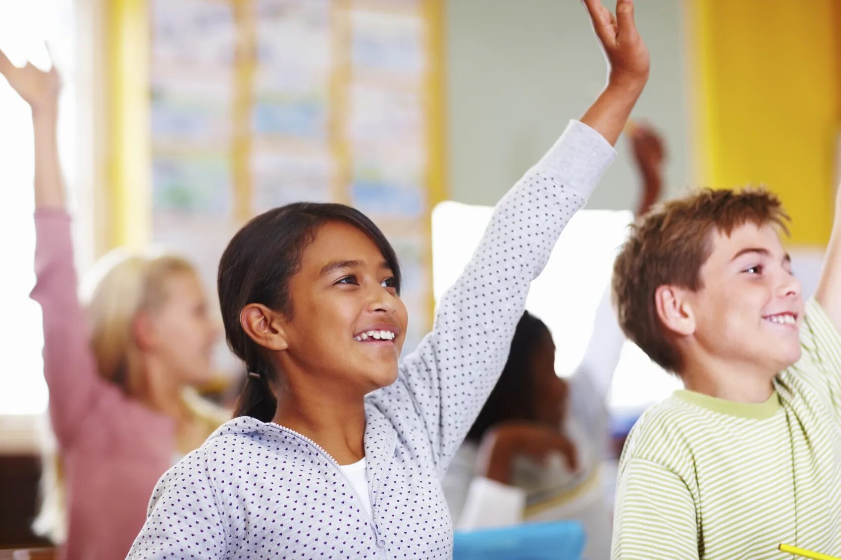 Talent teacher. School student. School student raising hand. Emotional Learning. Two School girls are raising their hands.