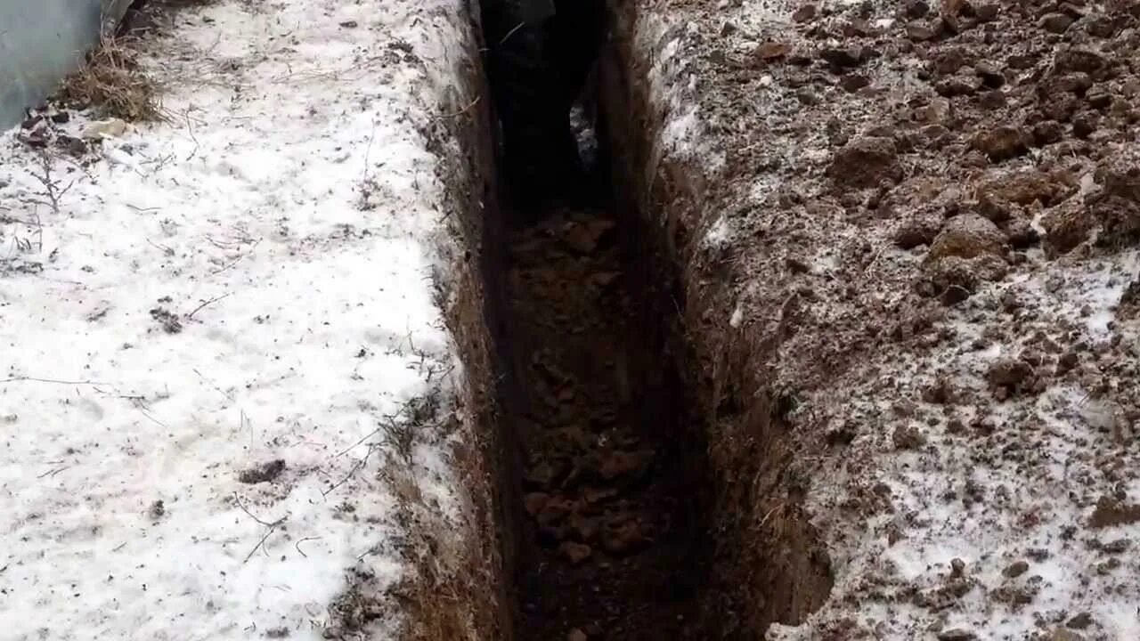 Фундамент делают зимой. Траншея зимой. канава зимой. копка траншей зимой. копание траншеи зимой.