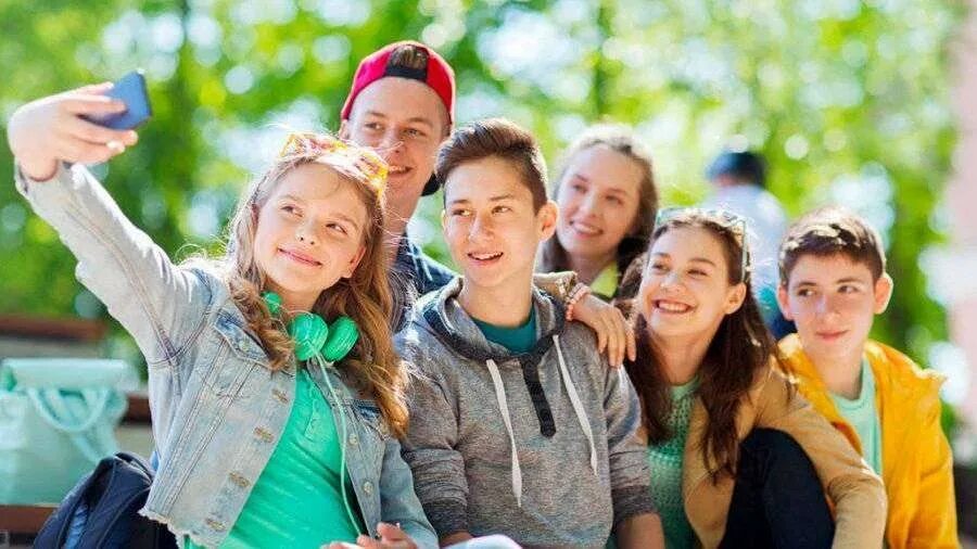 Teenage Friends in Headphones Looking at a Laptop Stock Image - Image of lifesty