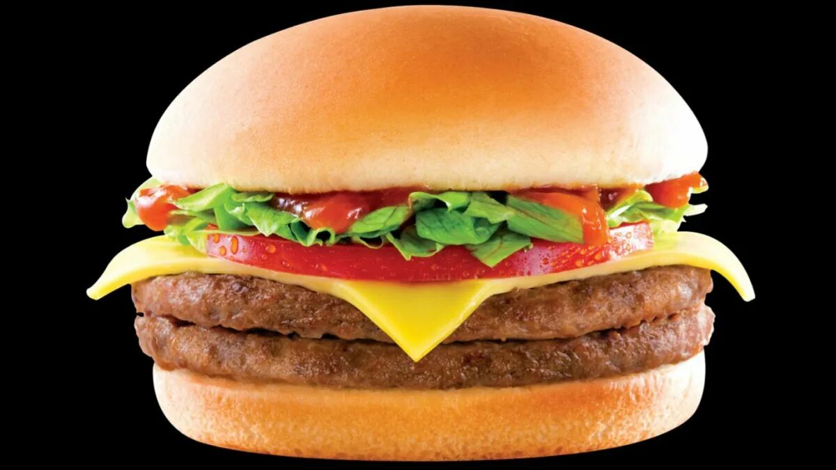 Про гамбургер. Бургер. Сочный гамбургер. Бургер на черном фоне. Чизбургер на черном фоне.
