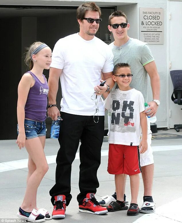 Mark Wahlberg and his family cool off in the ocean following Easter church servi