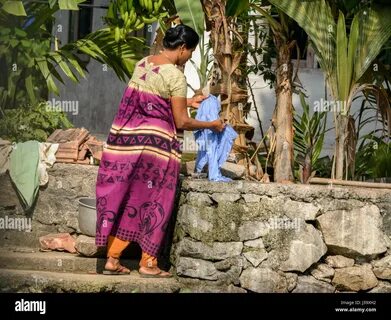 Download this stock image: Daily life: A Keralan woman does her washing on ...