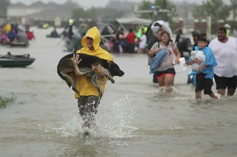 People evacuate their homes after the area was inundated with flooding from...