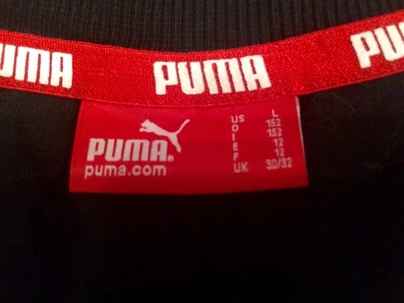 Как отличить пума. Puma бирка. Оригинальная бирка Пума. Бирки футболки Puma. Этикетка Puma оригинальная.