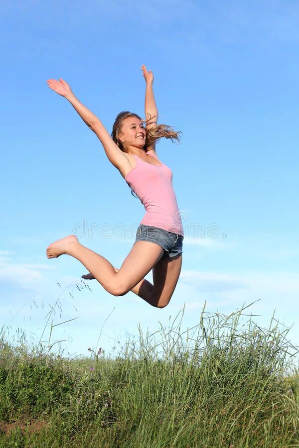 Молодая девушка прыгает. Молодые люди прыгают на траве. Молодая девушка прыгает. Человек прыгает. Девушки в прыжке летом.