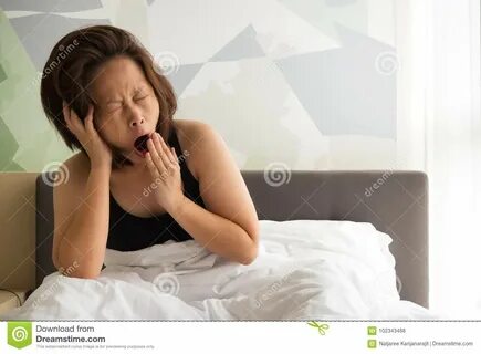 Woman yawning on bed. stock photo. 