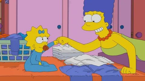 Marge and Maggie Simpson fist bump while folding laundry. 