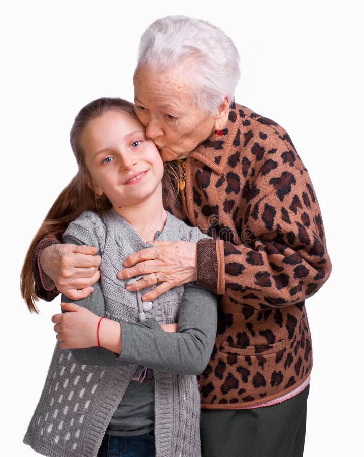 Бабушка и дедушка с внуками. Бабушка обнимает внучку. Бабушка целует. Дедушка с внучкой на руках.