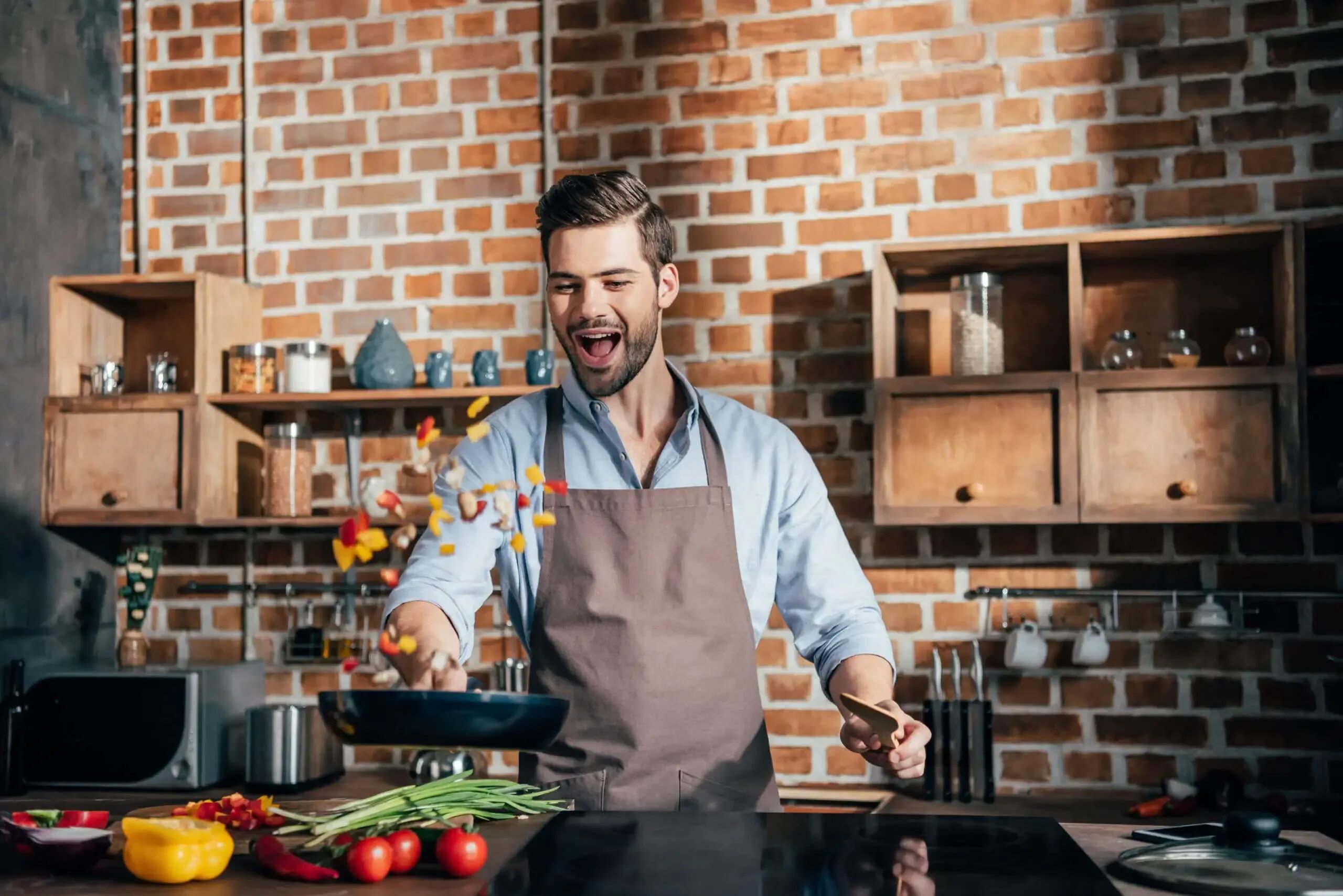 Мужчина на кухне. Готовка на кухне. Повар на кухне. Мужчина в фартуке на кухне.