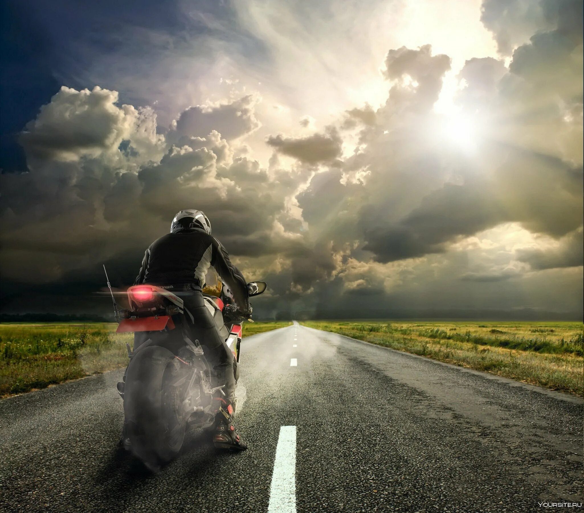 Легкая пыль несется по дороге далеко. Мотоцикл на дороге. Байкер на дороге. Пейзаж с мотоциклом. Мотоциклист на дороге.