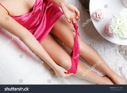 Стоковая фотография: Woman taking off her sexy panties in the bed. 