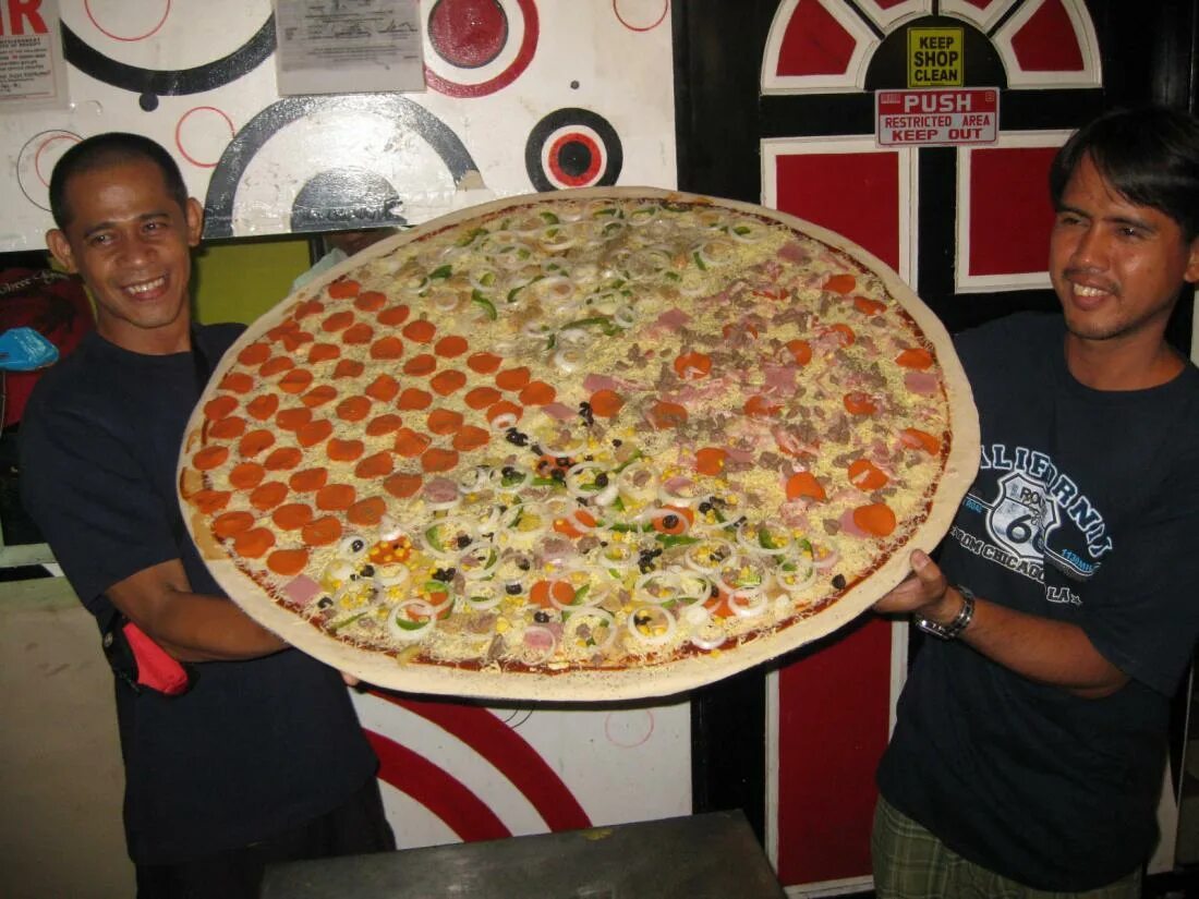 Пицца большие куски. Огромная пицца. Огромный кусок пиццы. Самая большая пицца. Самый большой кусок пиццы в мире.