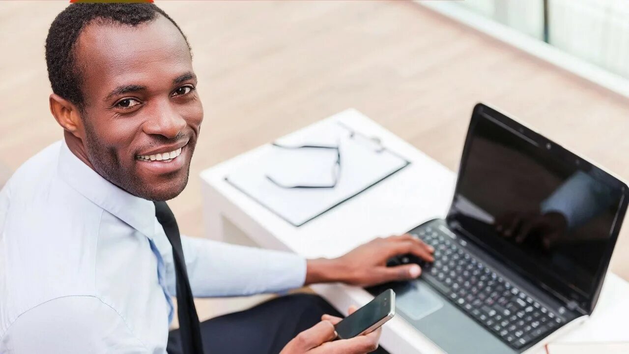 Homme noir. The man holding the Notebook. Laptop woman Home.