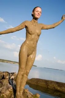 Beautiful naked girl in the mud 