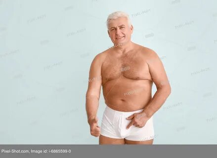 Mature man without urologic disease showing thumb-up on light background. 