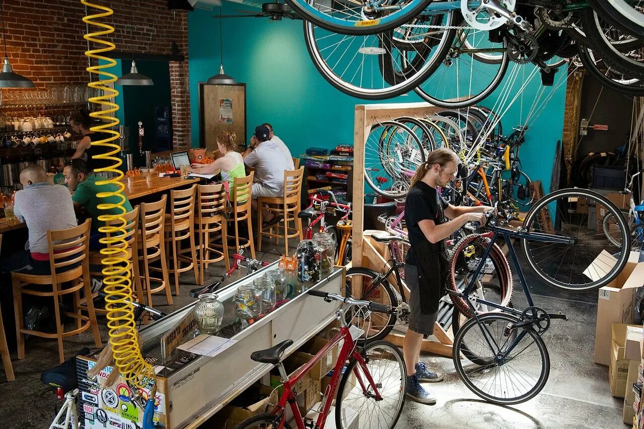 Выкаченный велосипед. Велосипед у кафе. Мастерская велосипедов. Кофейня на велосипеде. Велосипед в интерьере кафе.