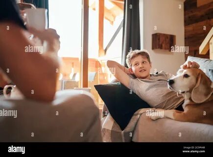 Boy lying in comfortable sofa an Stock Photo. 