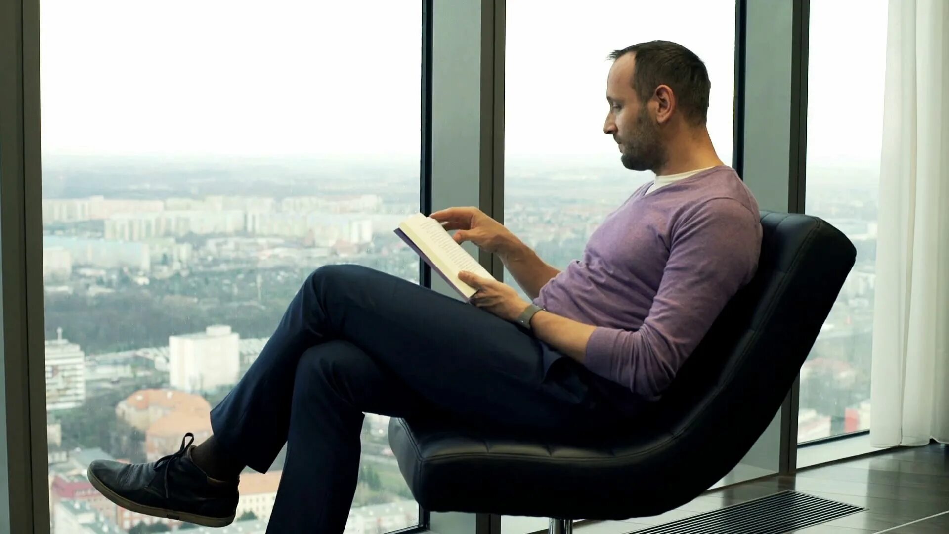 Man sitting of me. Sitting man with book. man reading. man sitting on chair. man on the armchair.