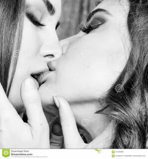 Two girls with soft tender mouths kissing closeup 