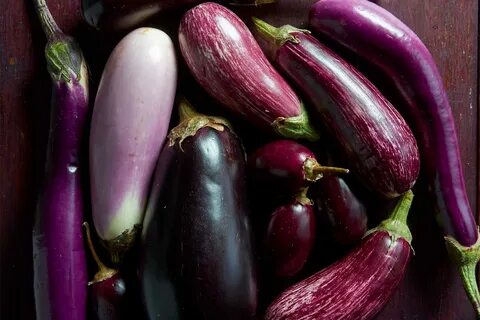 Photo: Andy Lyons/Meredith. different types of eggplants on wooden table. 